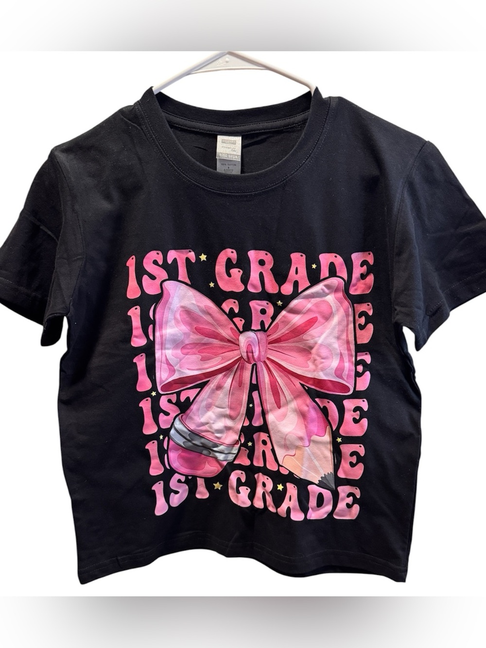 Next Level Apparel Kids Black Tee with Pink Bow "1st Grade" Graphic